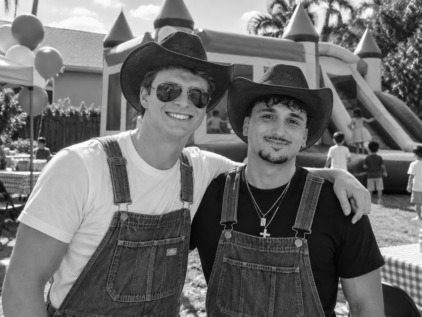 Matt and Ryan, the founders of Premier Inflatable Rentals, in front of a bounce house at a party